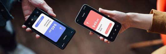 Closeup of two people managing online banking with smart phone